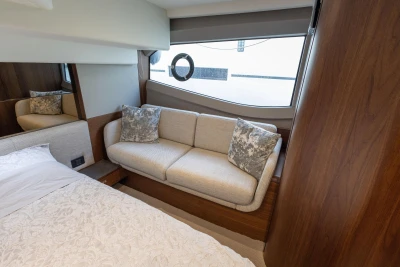 Luxurious interior of 2023 Princess F50 yacht with elegant sofa and bedding.
