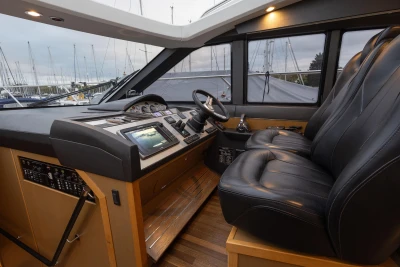 Luxurious 2014 Princess V52 yacht cockpit with leather seats and advanced navigation controls.