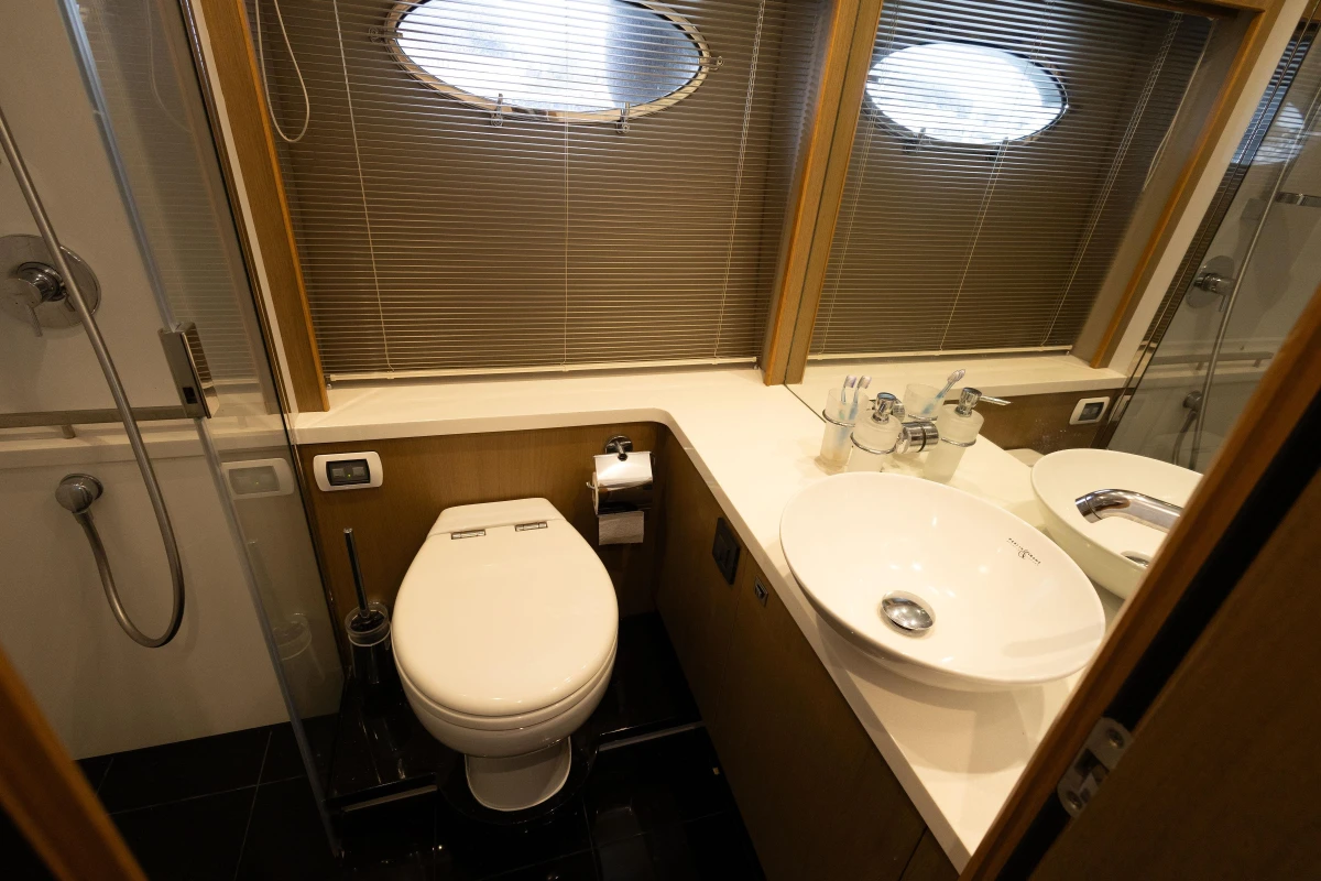 Luxurious bathroom in 2014 Princess V52 yacht with modern fixtures and porthole windows.