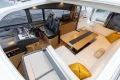 Luxurious interior of 2014 Princess V52 yacht with leather seating and modern helm.