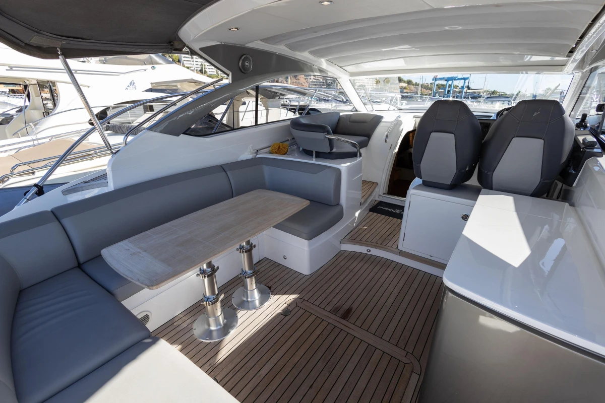 Luxurious 2017 Princess V40 yacht interior with seating and wooden flooring.