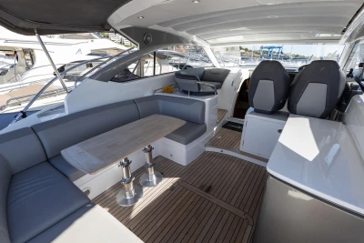 Luxurious 2017 Princess V40 yacht interior with seating and wooden flooring.