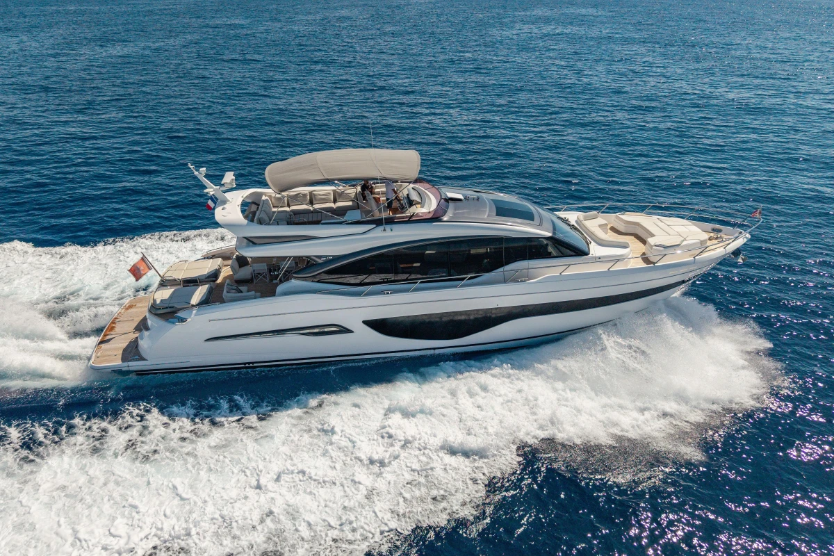 Luxurious 2022 Princess S78 yacht cruising on open sea, showcasing sleek design and elegance.