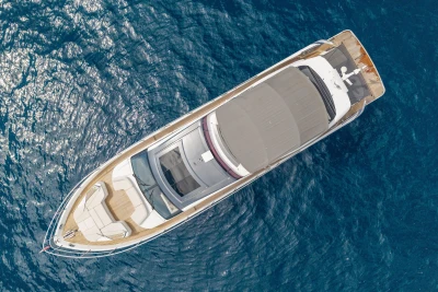 Aerial view of 2022 Princess S78 yacht on blue ocean water.