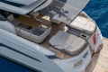 Luxurious 2022 Princess S78 yacht deck with seating and dining area on blue water.