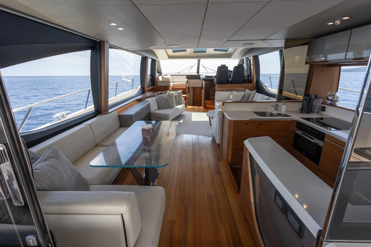 Luxurious interior of 2022 Princess S78 yacht with modern kitchen and seating area.