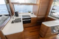 Luxurious kitchen interior of 2022 Princess S78 yacht with modern appliances and wooden finishes.