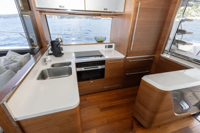 Luxurious kitchen interior of 2022 Princess S78 yacht with modern appliances and wooden finishes.