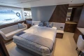 Luxurious 2023 Princess S72 yacht bedroom with elegant decor and scenic window views.
