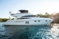 Luxury 2008 Princess 58 yacht on serene water with scenic background.