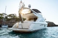 Luxurious 2008 Princess 58 yacht anchored in scenic coastal waters.