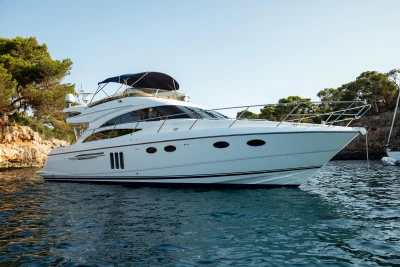 Luxury 2008 Princess 58 yacht cruising in scenic coastal waters.