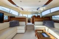 Luxurious interior of a 2008 Princess 58 yacht with elegant seating and panoramic windows.