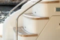 Staircase on 2008 Princess 58 yacht with sleek design and wooden steps.