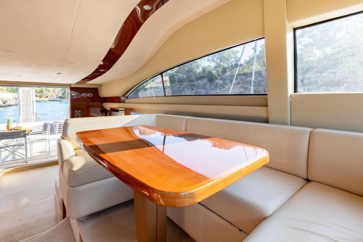 Luxurious interior of 2008 Princess 58 yacht with elegant wooden table and plush seating.
