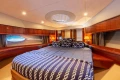 Luxurious bedroom interior of 2008 Princess 58 yacht with elegant wood finishes.