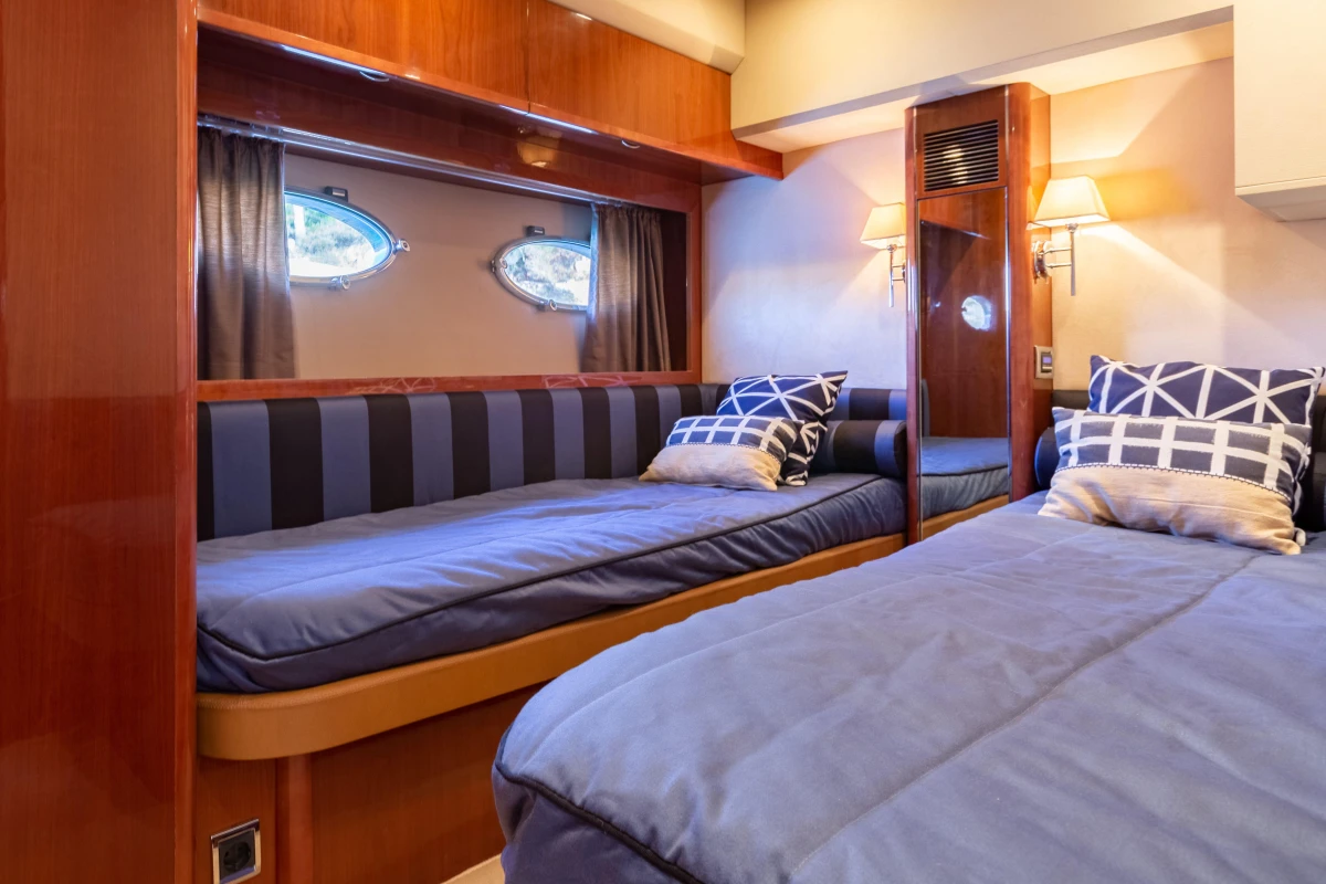 Luxurious cabin interior of 2008 Princess 58 yacht with twin beds and elegant decor.