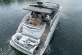 2023 Princess V50 yacht cruising with tender on calm water.
