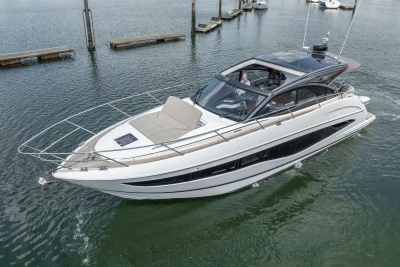 2023 Princess V50 yacht cruising in a marina, showcasing sleek design and luxury features.