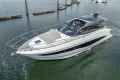 2023 Princess V50 yacht cruising in a marina, showcasing sleek design and luxury features.