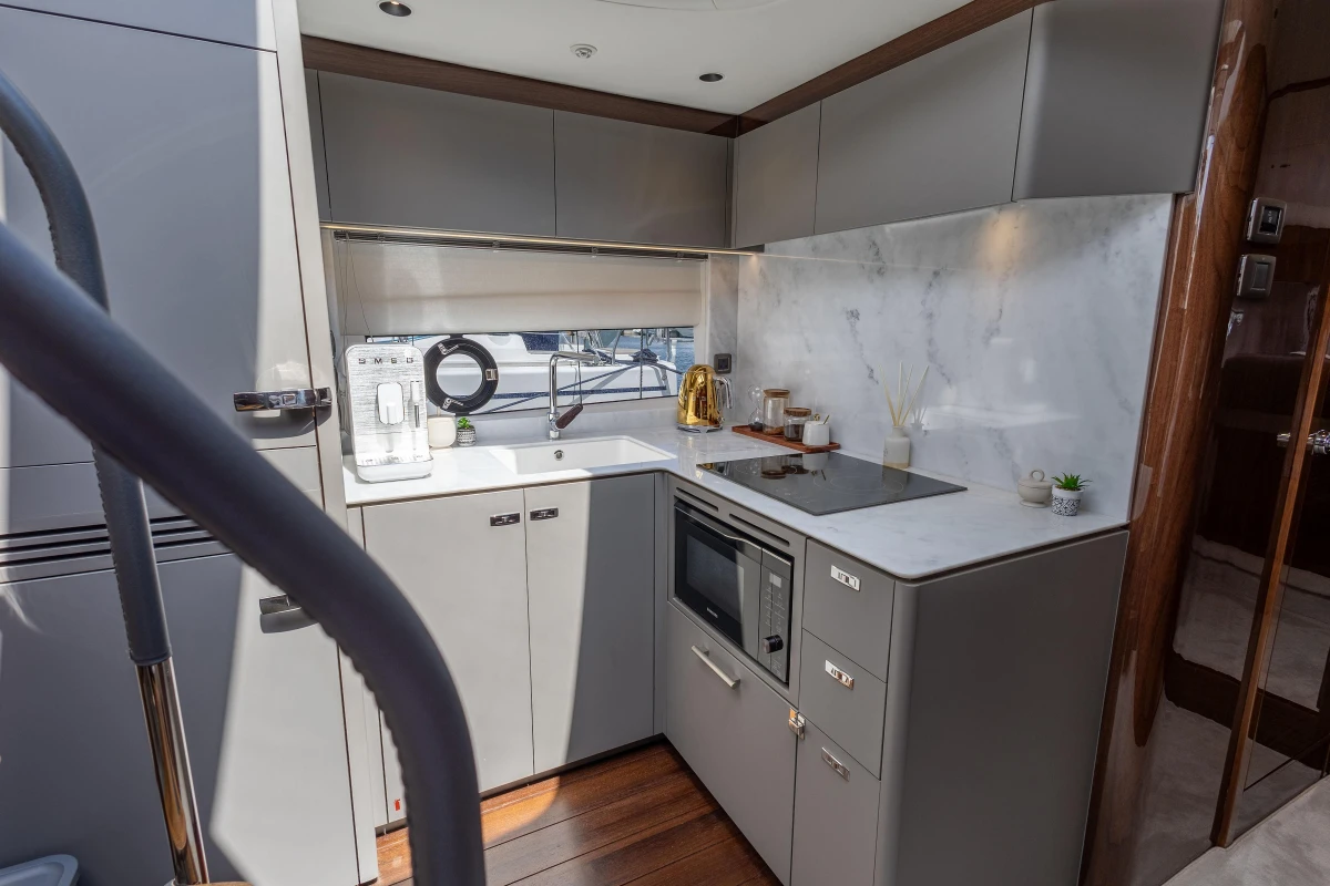 Modern kitchen in 2023 Princess V50 yacht with sleek cabinetry and appliances.