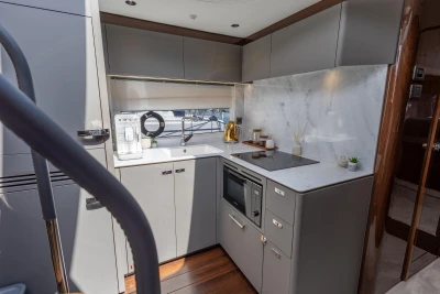 Modern kitchen in 2023 Princess V50 yacht with sleek cabinetry and appliances.