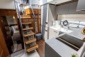Luxurious interior of 2023 Princess V50 yacht with modern kitchen and stylish staircase.
