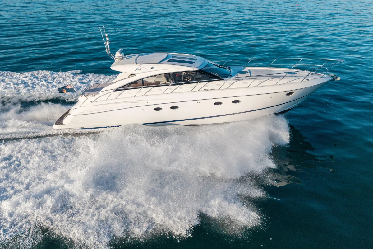 2006 Princess V53 yacht cruising on open water, creating a dynamic wake.