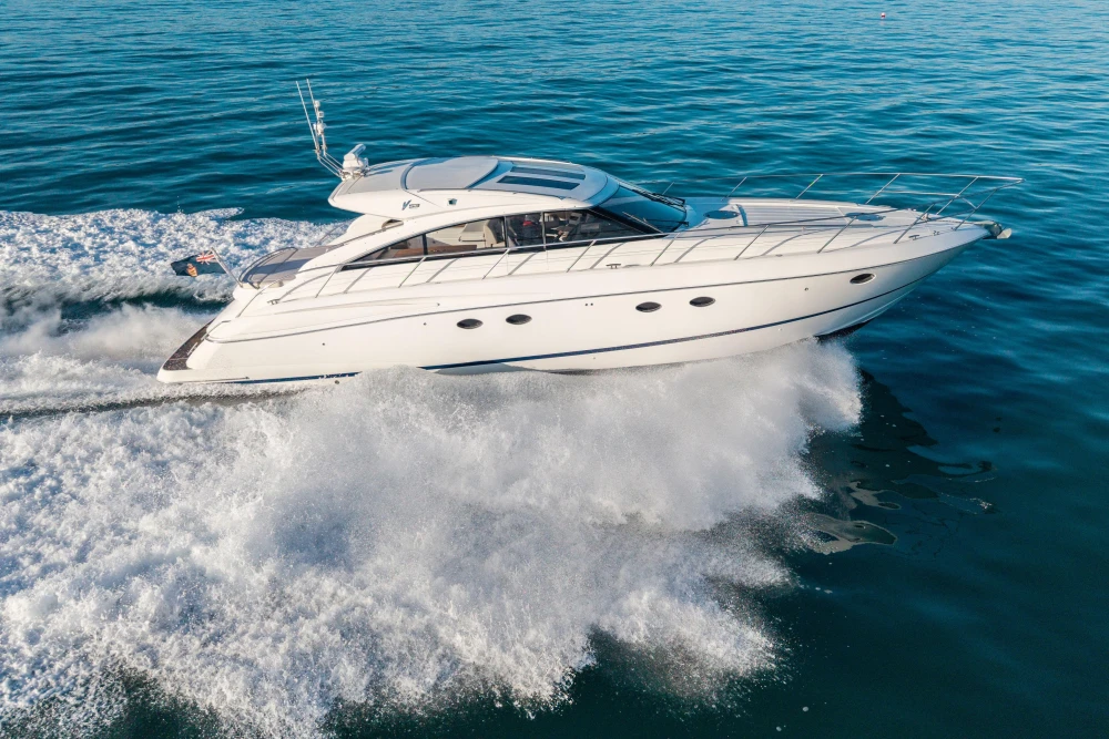 2006 Princess V53 yacht cruising on open water, creating a dynamic wake.