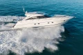 2006 Princess V53 yacht cruising on open water, creating a dynamic wake.