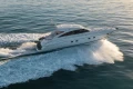 2006 Princess V53 yacht cruising on open water, creating a dynamic wake.