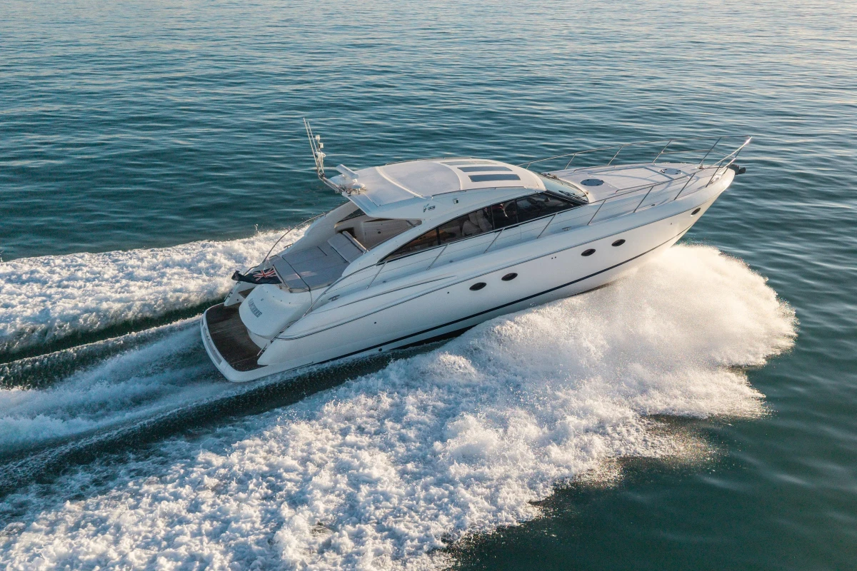 2006 Princess V53 yacht cruising on open water, creating a dynamic wake.