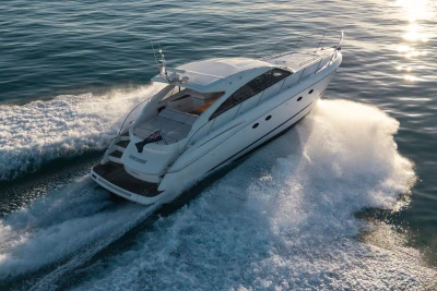 2006 Princess V53 yacht cruising on open water at sunset.