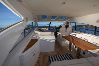 Luxurious 2006 Princess V53 yacht interior with elegant seating and wooden table.