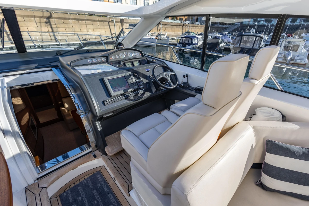Luxurious 2006 Princess V53 yacht cockpit with modern navigation controls and plush seating.