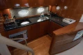 Luxurious 2006 Princess V53 yacht kitchen with modern appliances and sleek wood finish.