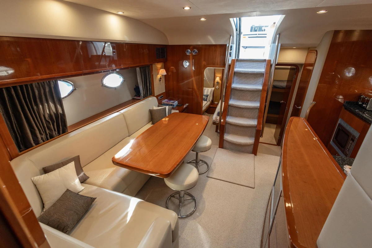 Luxurious interior of 2006 Princess V53 yacht with elegant seating and dining area.