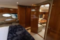 Luxurious interior of 2006 Princess V53 yacht with wood finishes and cozy seating area.