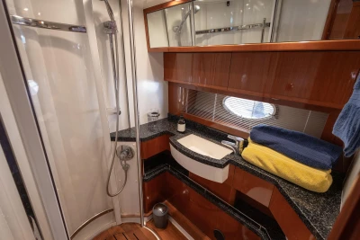 Luxurious bathroom in 2006 Princess V53 yacht with modern fixtures and elegant wood finishes.