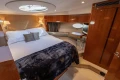 Luxurious 2006 Princess V53 yacht cabin with elegant wood finishes and cozy bedding.