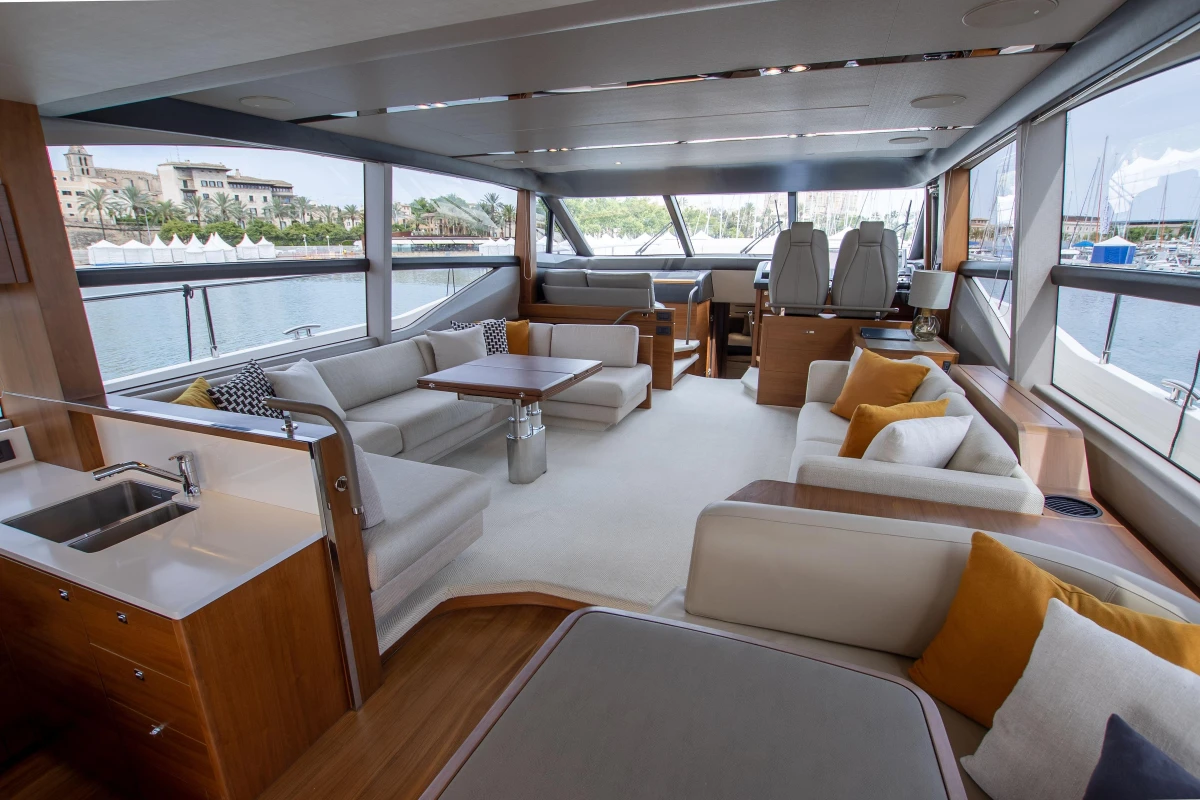 Luxurious interior of a 2015 Princess 68 yacht with elegant seating and panoramic windows.