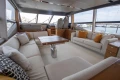 Luxurious interior of a 2015 Princess 68 yacht with elegant seating and panoramic windows.