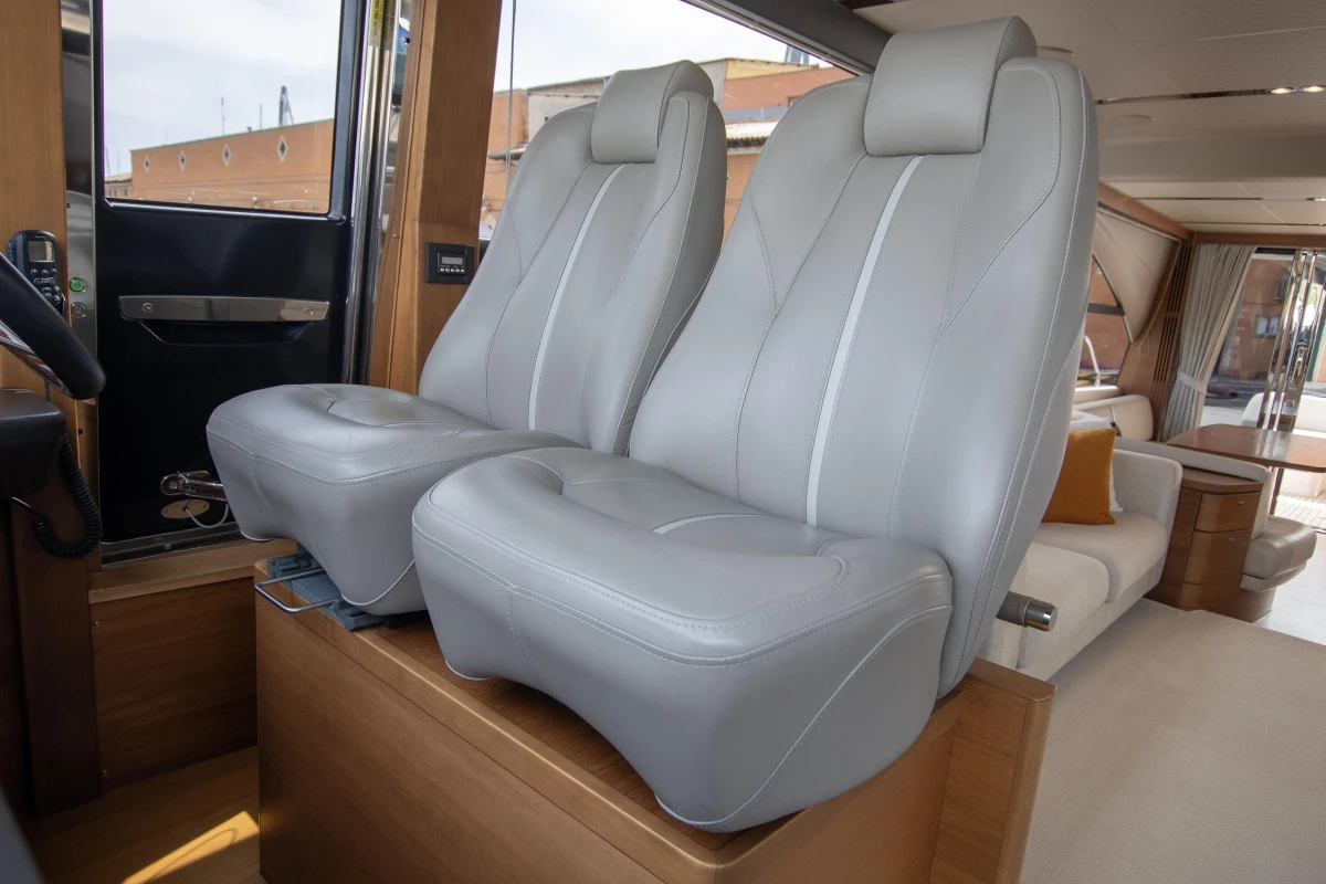 Luxurious interior of 2015 Princess 68 yacht with plush gray seating.