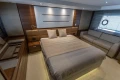 Luxurious bedroom interior of 2015 Princess 68 yacht with modern design and cozy furnishings.