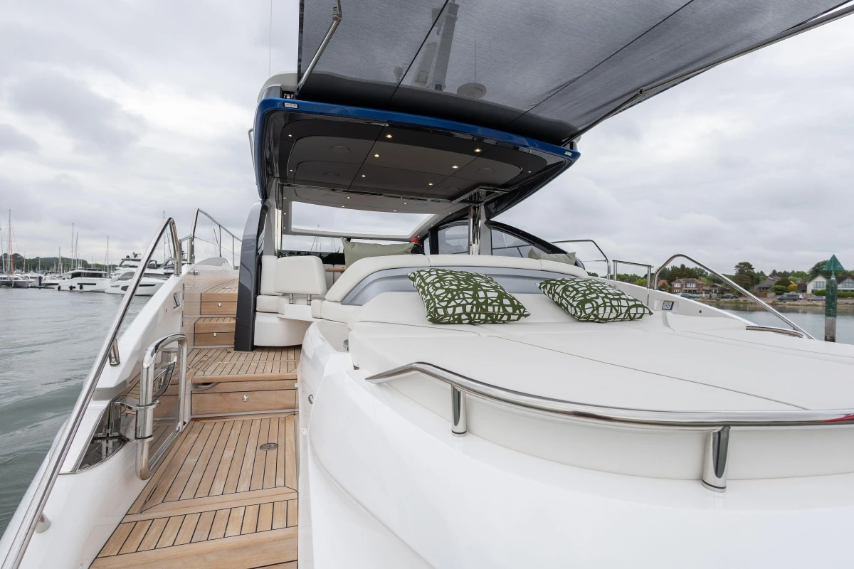 2025 Princess V55 yacht with luxurious deck and seating area, docked at marina.