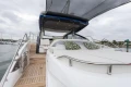 2025 Princess V55 yacht with luxurious deck and seating area, docked at marina.