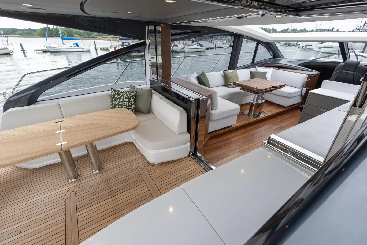 Luxurious 2025 Princess V55 yacht interior with elegant seating and wooden flooring.