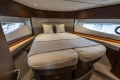 Luxurious interior cabin of 2025 Princess V55 yacht with elegant bedding and modern design.