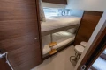 2025 Princess V55 yacht cabin with wooden interior and bunk beds.