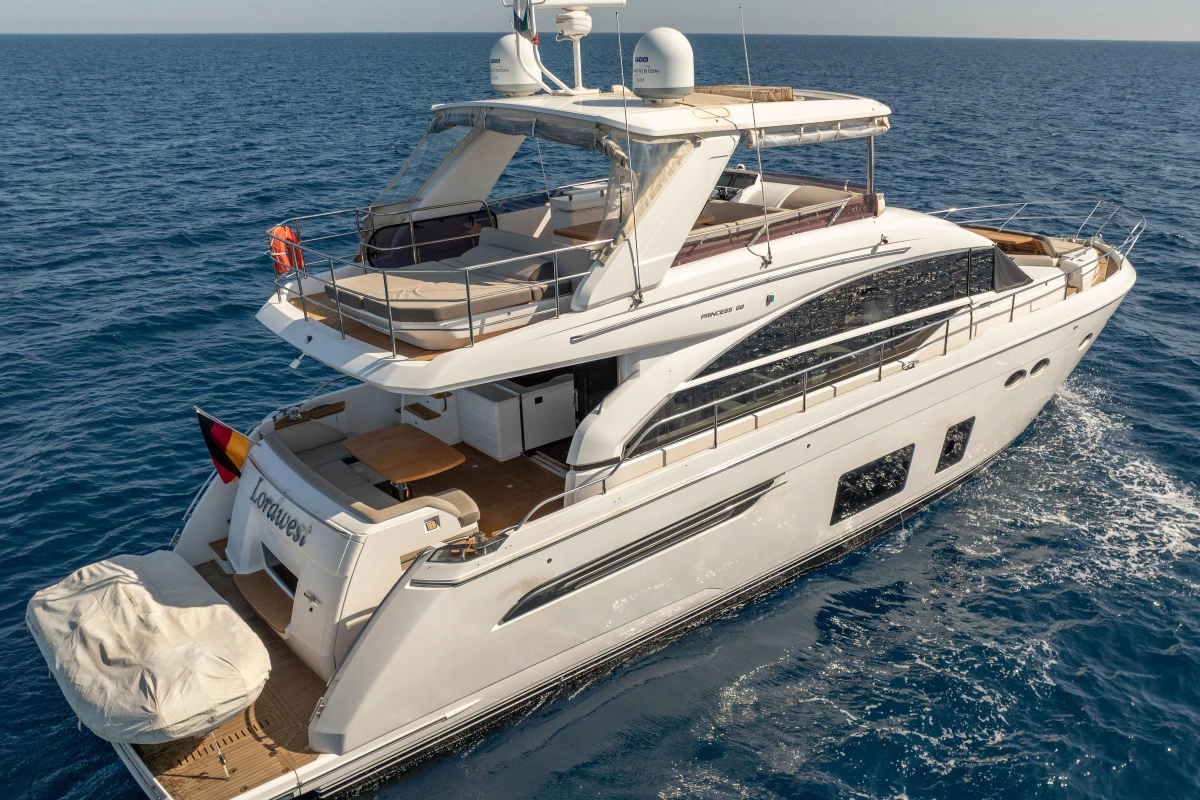 Luxurious 2017 Princess 68 yacht cruising on open sea, showcasing elegant design and spacious decks.